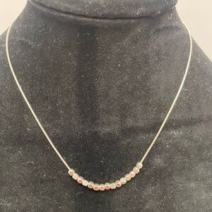 Necklace with small gold and silver tone beads.